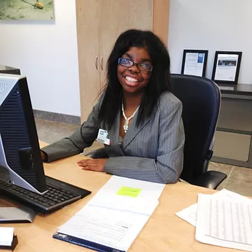 African American woman with disabilities working on a company in an office.