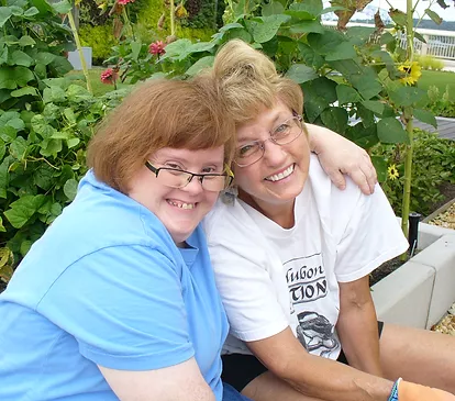 Two women looking into and smiling at the camera.