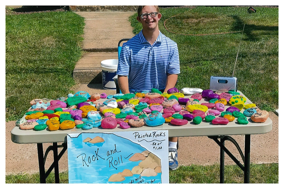 Client selling painted rocks on a warm afternoon